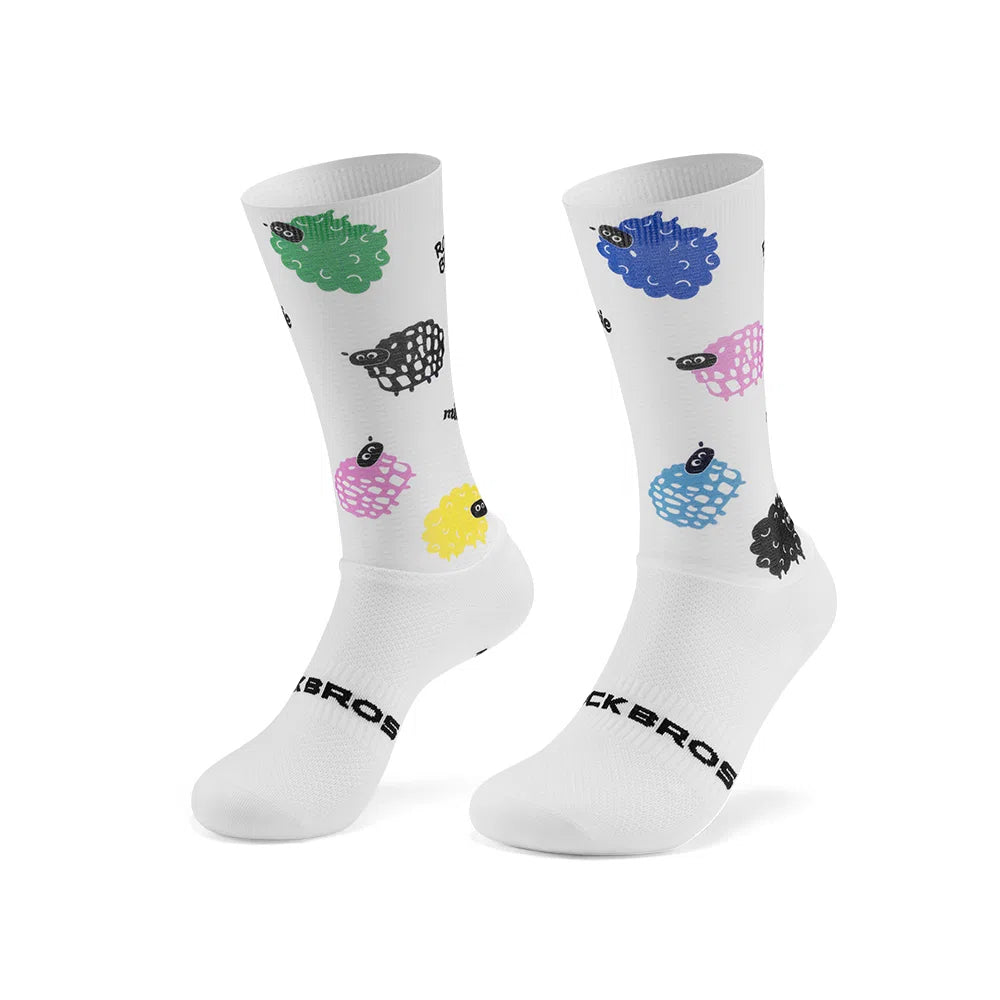 A pair of white crew socks with a pattern of colorful, stylized sheep in green, blue, black, pink, and yellow, featuring the brand name 'ROCKBROS' printed in black near the foot. #Color_Lamb