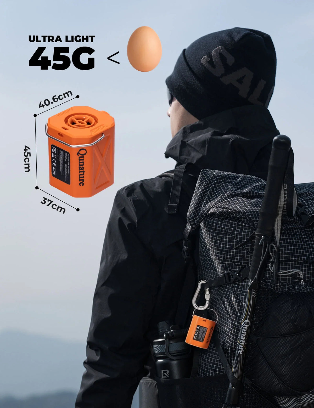 Person wearing a black jacket with an orange ultra-light 45G device attached, set against a mountainous background.
