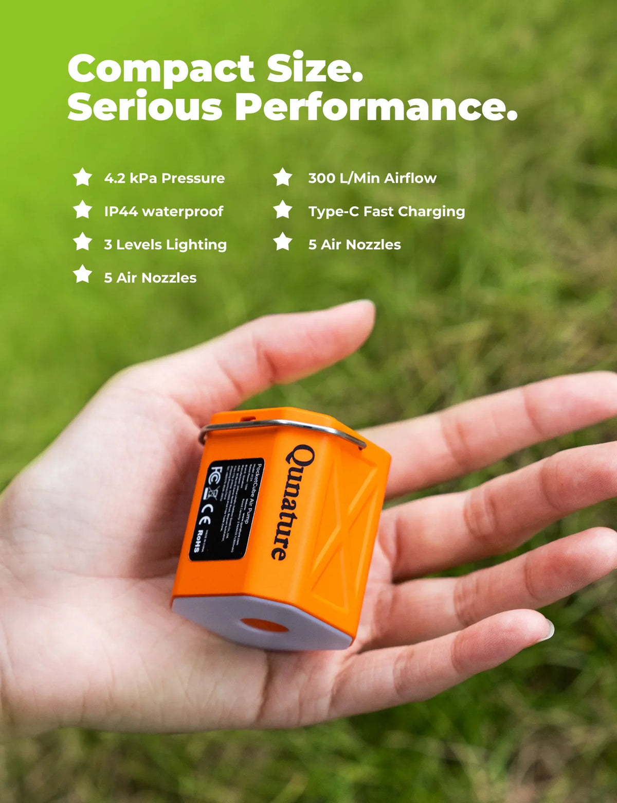 Orange device held in a hand with grass background and feature text overlay