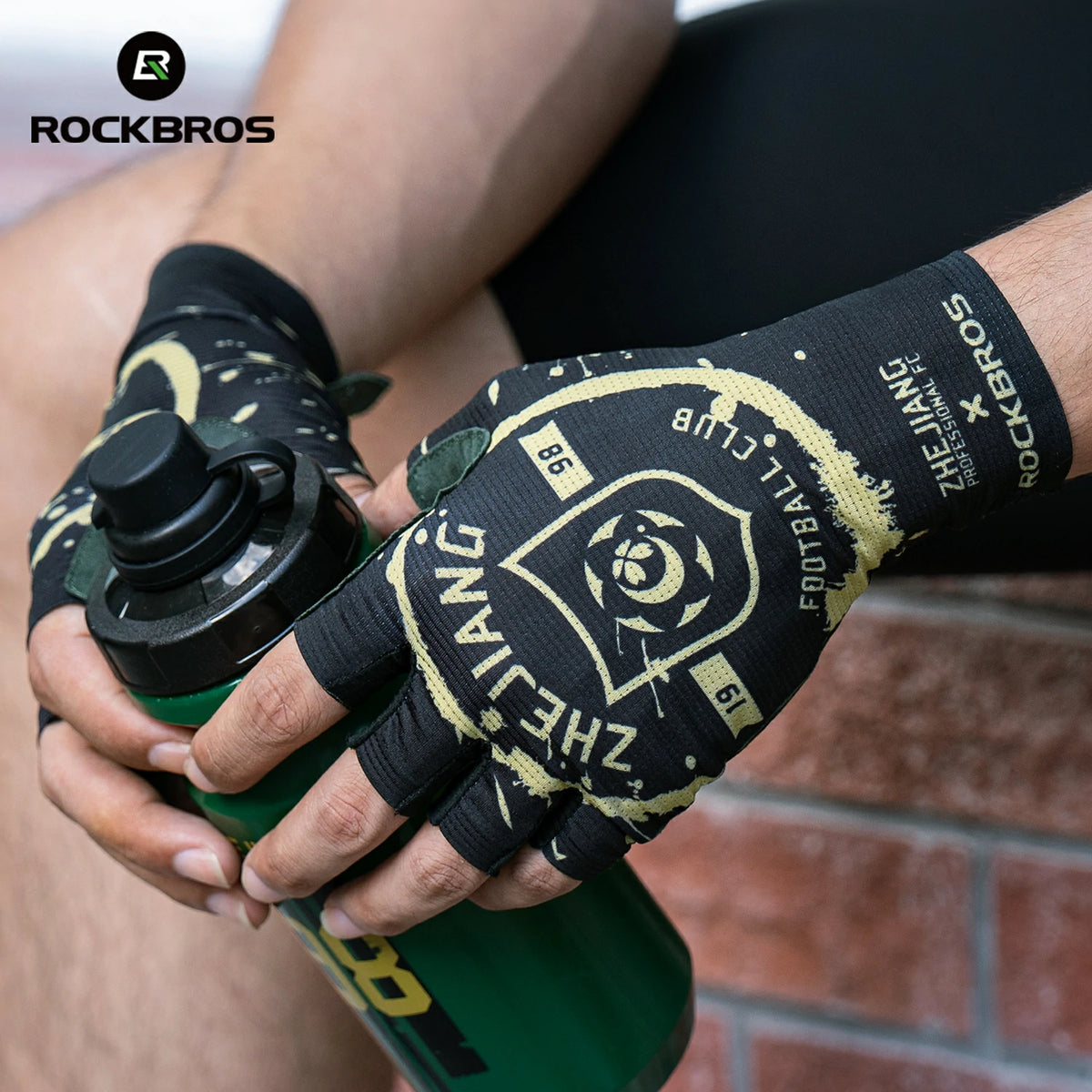 Person wearing a black and yellow glove holding a green water bottle with 'ROCKBROS' branding.