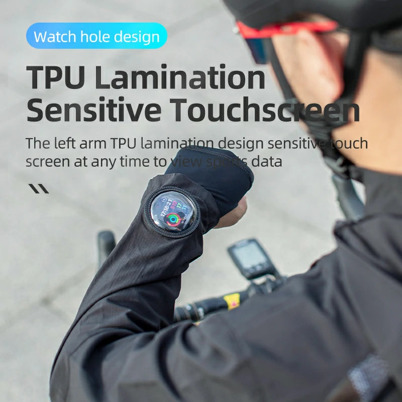 Person wearing a black glove with a touch screen on the left arm, outdoors.