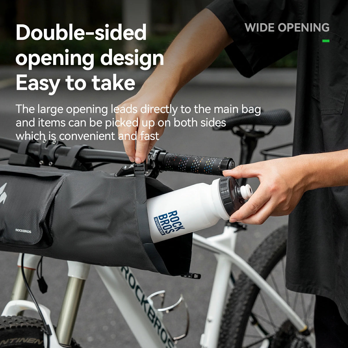 Person using a bike bag with a water bottle, highlighting its wide opening design.