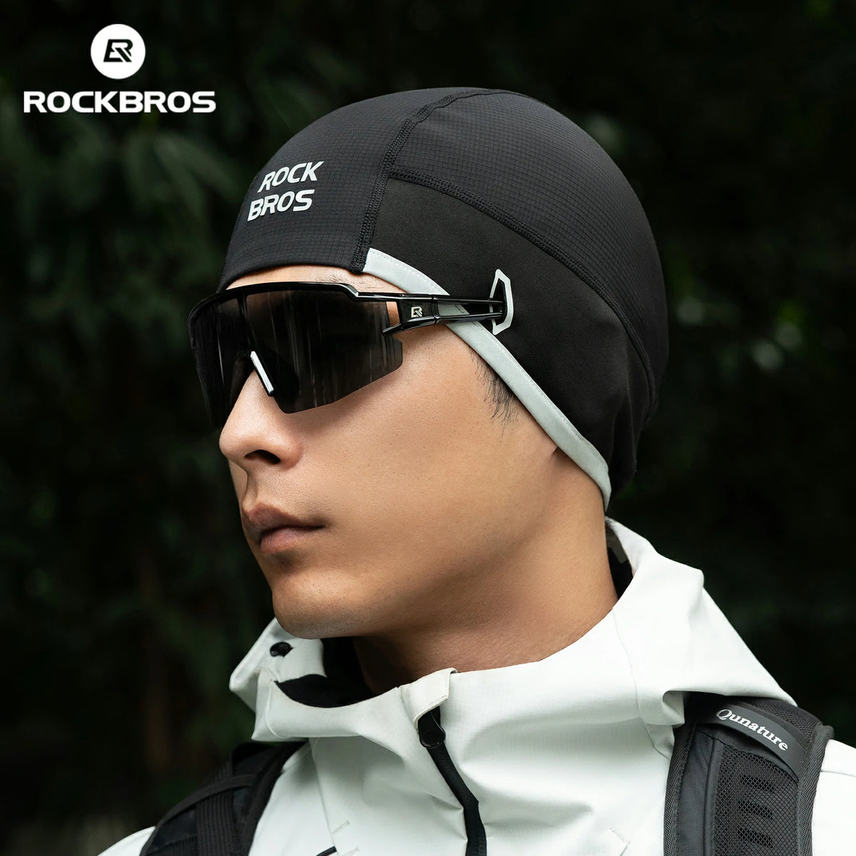 Person wearing a black beanie with 'RockBros' branding and sunglasses, set against a blurred natural background.