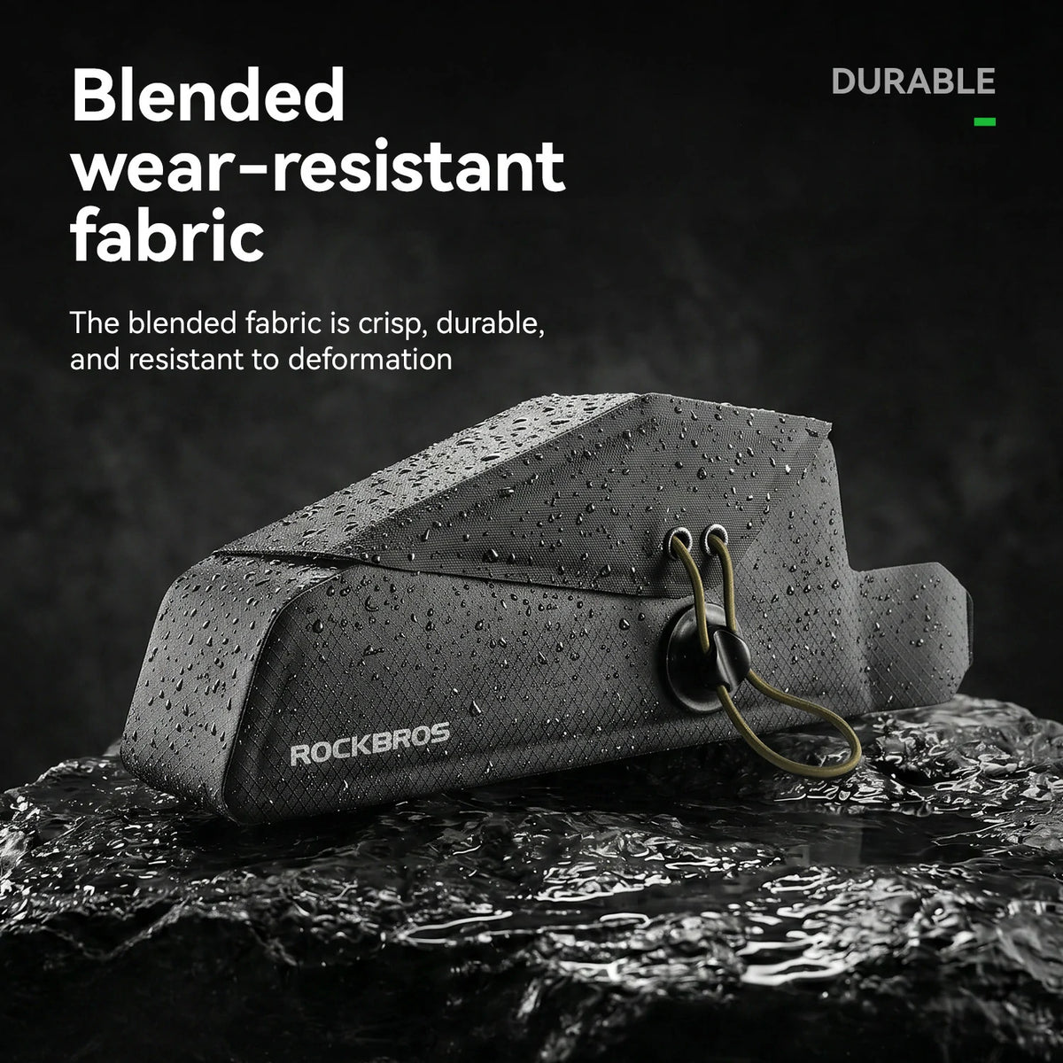 A black Rockbros bag with water droplets on its surface, resting on wet rocks with promotional text highlighting its durable, blended wear-resistant fabric.