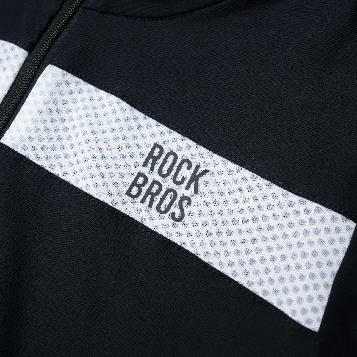 Close-up of a black and white jacket with 'Rock Bros' branding.