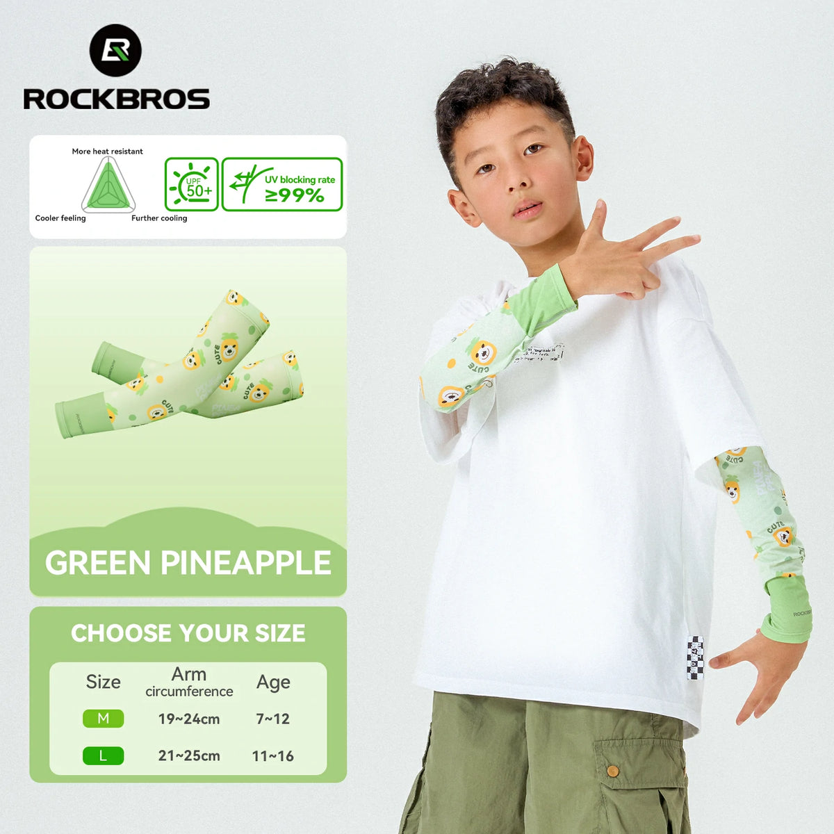 Child wearing a white shirt with green pineapple designs on sleeves, standing next to product packaging. #Color_Green