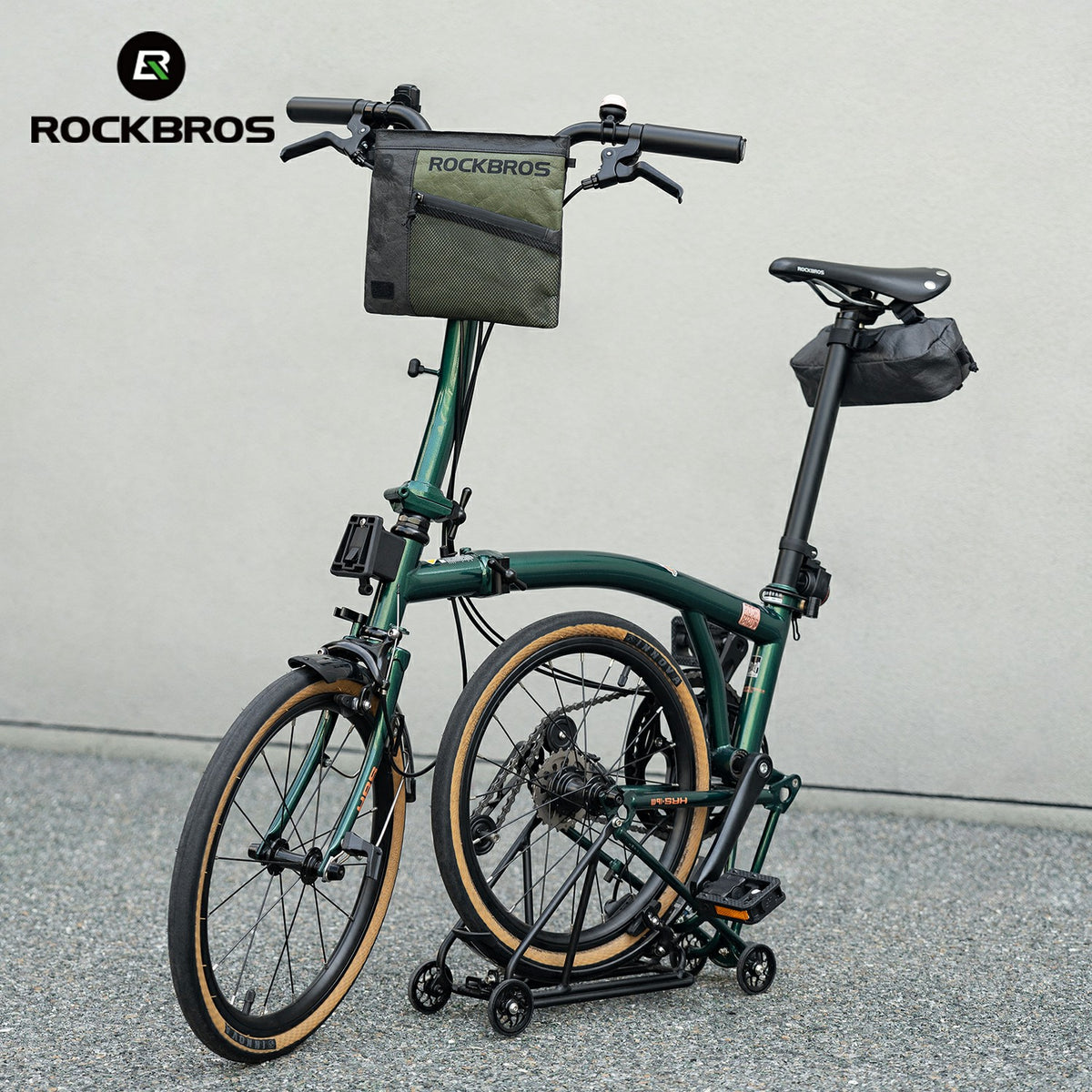 Green folding bike with storage bags on a gray background, featuring the RockBros brand.