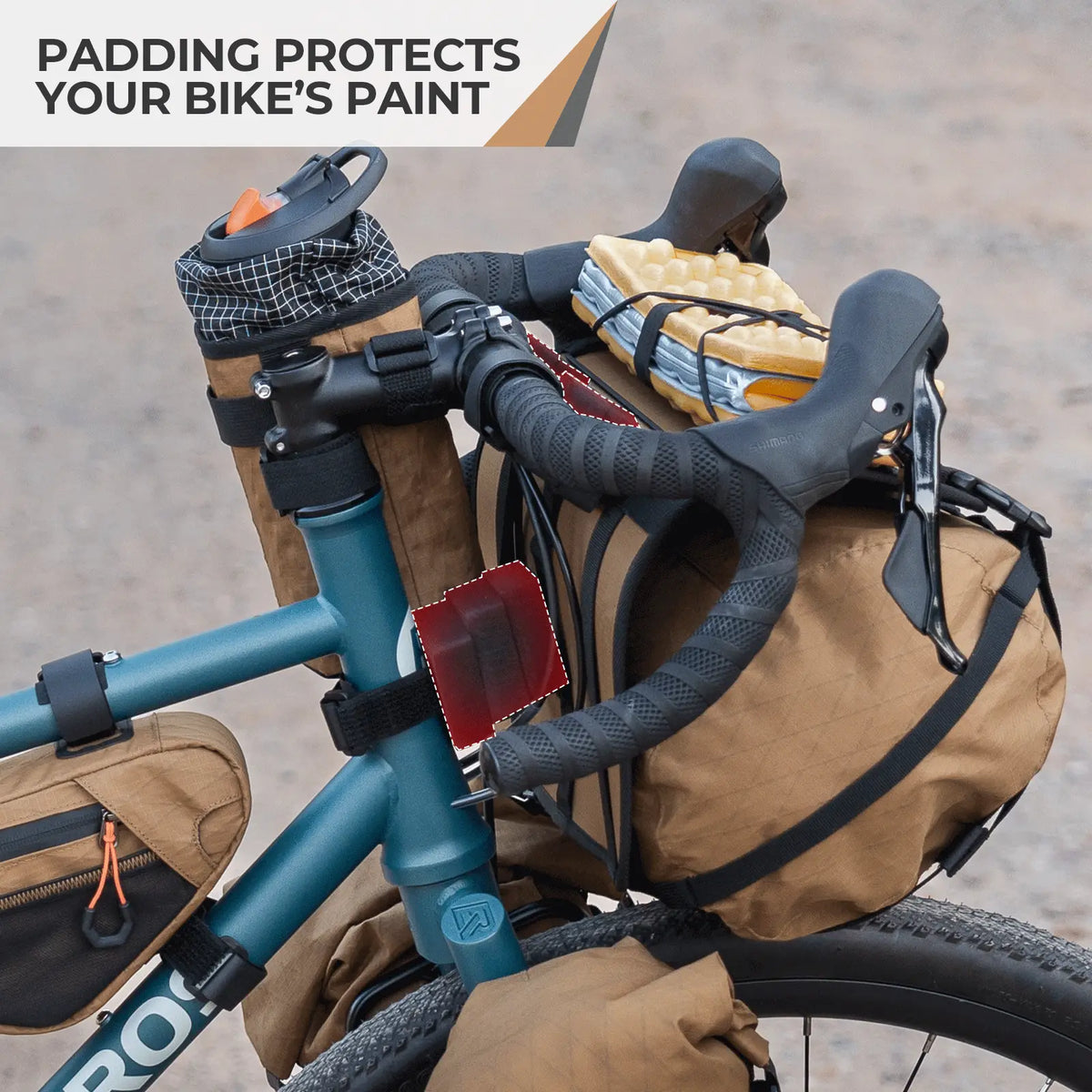 Bicycle with brown saddlebags and padding on a blurred road background
