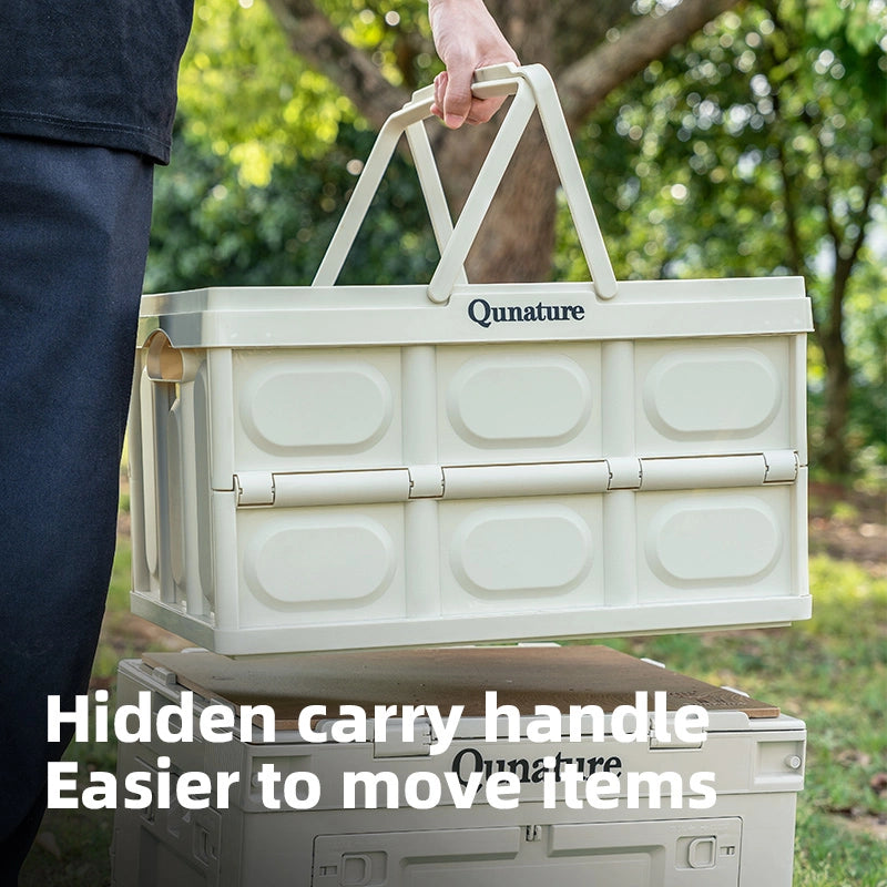 Beige storage bin with a visible 'Qunature' brand name, held by a person outdoors.