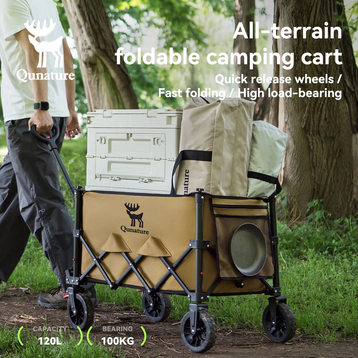 A man pulling a utility wagon full of camping supplies outdoors