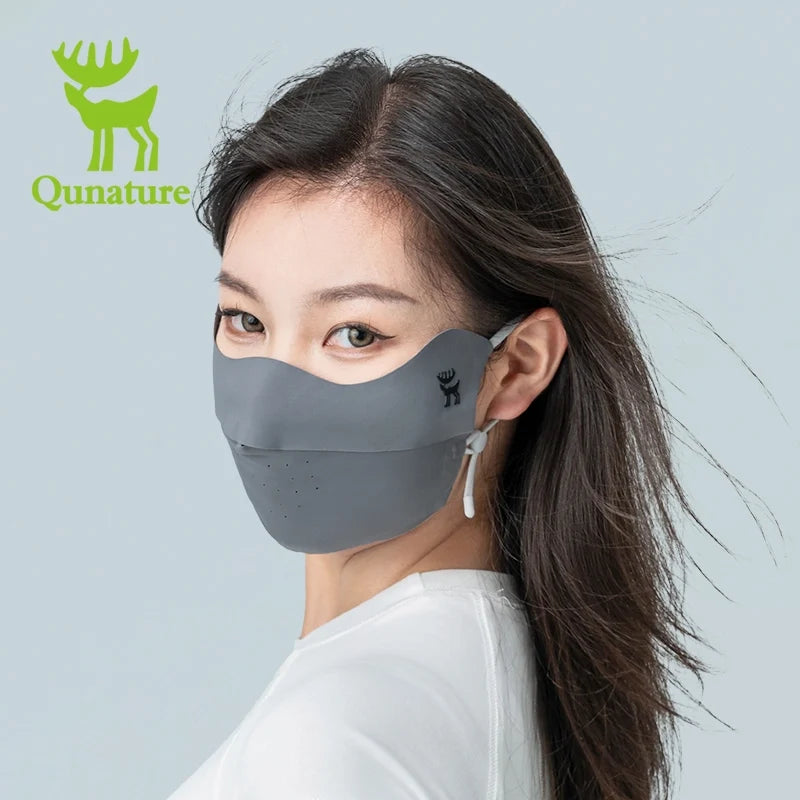 Woman wearing a face mask with Qunature branding on a gray background