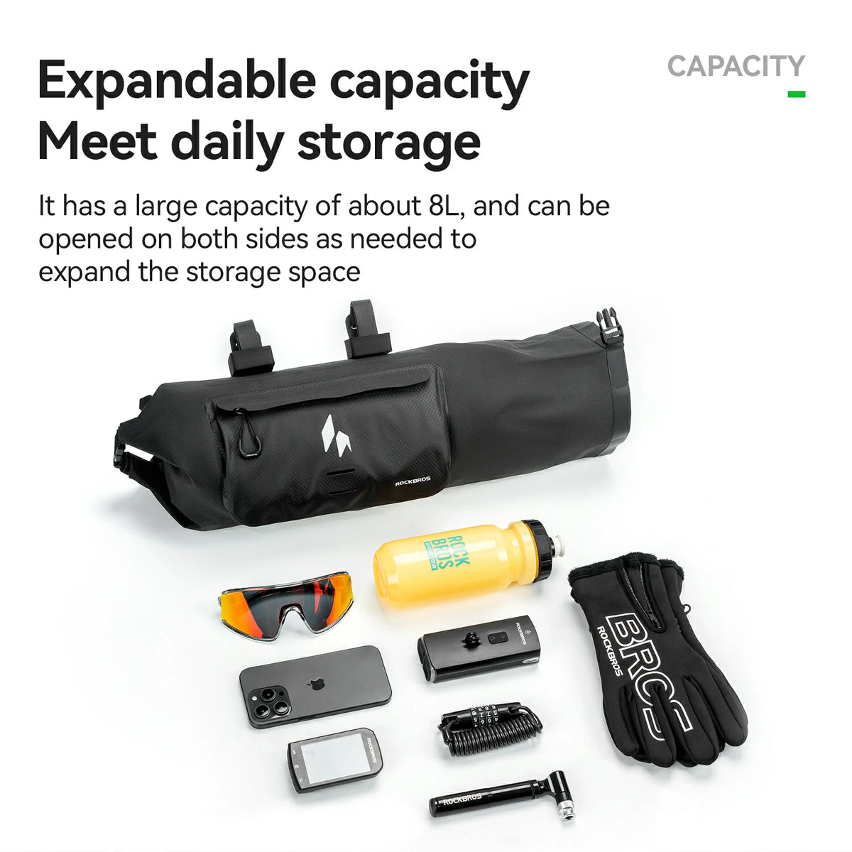 Black expandable storage bag with various items on a white background