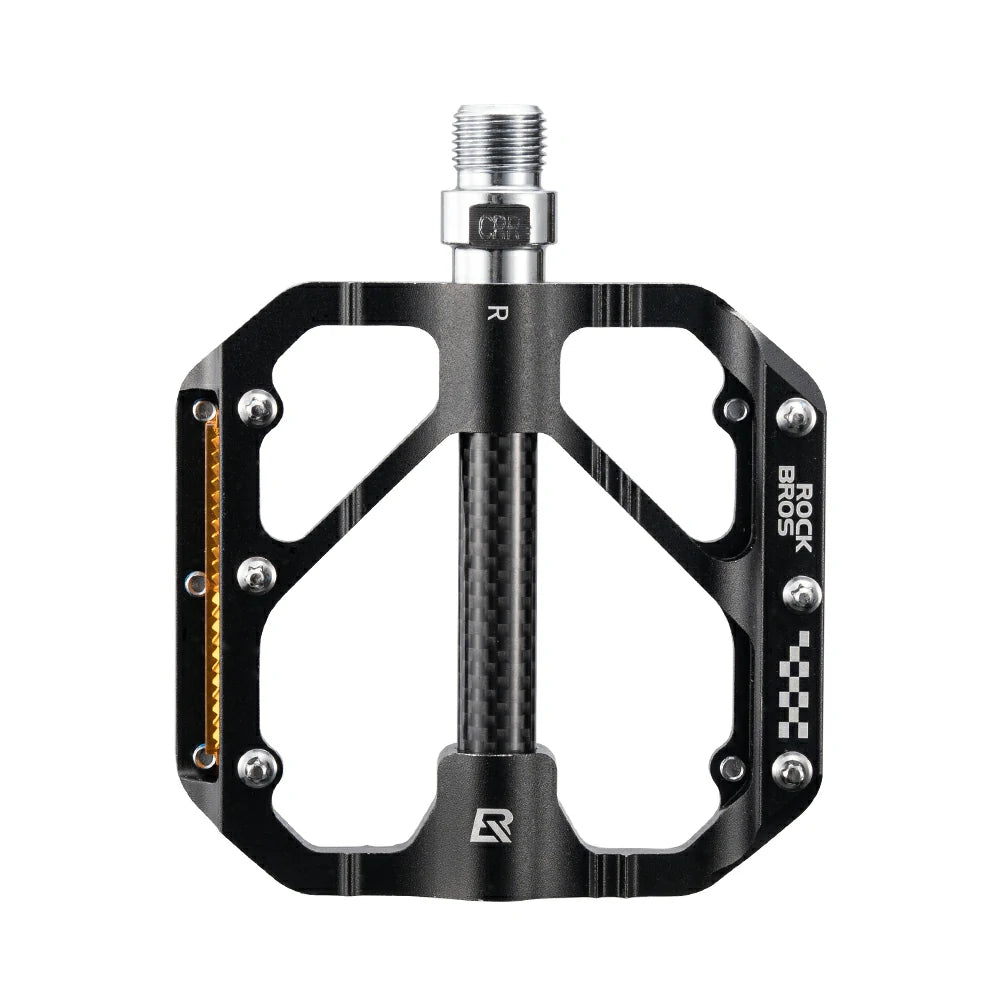 A black RockBros bicycle pedal with a threaded bottom bracket spindle, featuring a carbon fiber center section, silver hardware, and white branding on a solid white background.